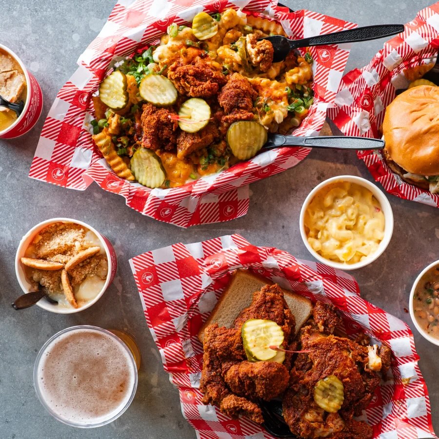 A Hattie B's spread of hot chicken, loaded fries, mac and cheese and banana pudding
